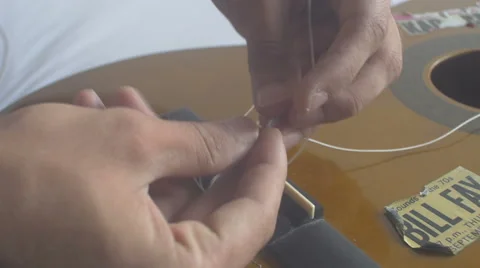 Restringing Your Classical Guitar (turning) bridge 1 Stock Footage 68023383