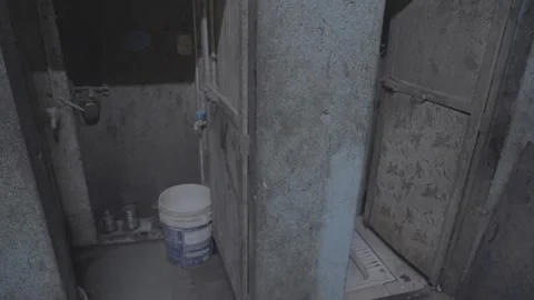 A restroom and workers' clothing at a workshop in Mumbai, India Stock Footage 345389746