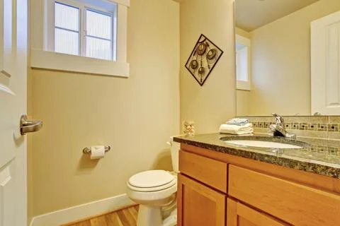 Restroom with maple vanity cabinet Stock Photos