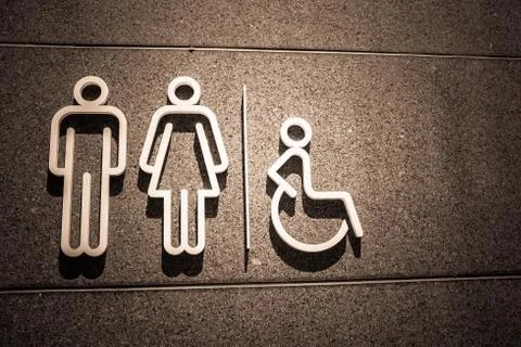 Restroom symbol on mable wall in Dark style Stock Photos