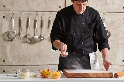 Restuarant hotel private chef dusting flour on board Stock Photos