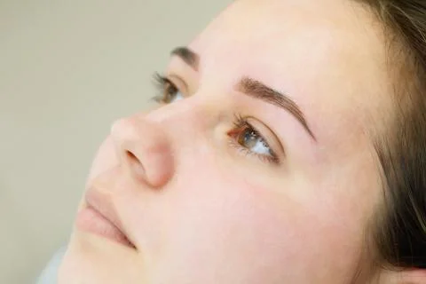 Result of permanent makeup, tattooing of eyebrows Stock Photos
