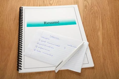 Resume and interview notes on oak wooden surface Stock Photos