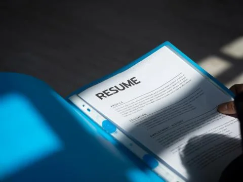 Resume documents or curriculum vitae paper in hands of a unemployed man appli Stock Photos