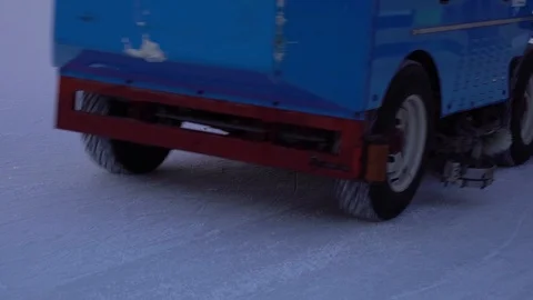 Resurfacing machine cleaning ice of open air skating rink in slow motion Stock Footage 102955399