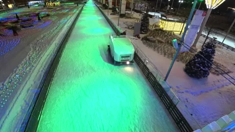 Resurfacing Machine Cleaning Ice Of Open Air Skating Rink Stock Footage 146194820