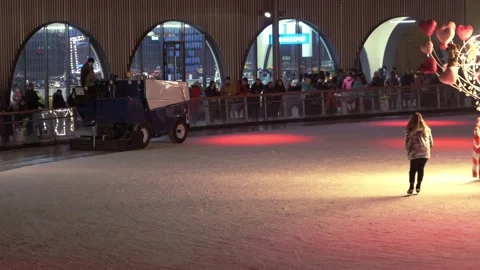 Resurfacing machine cleaning ice of open air skating rink Stock Footage 149079630