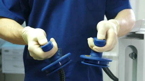 Resuscitator holding defibrillation electrode in hand. Preparing for Stock Footage 152960947