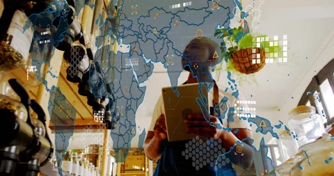Retail clerk swiping tablet while map overlay fading in and monitoring global Stock Footage 310864302