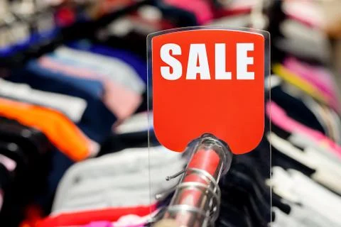 Retail clothes store clearance. Garment shop with various bright youth casual Stock-Fotos