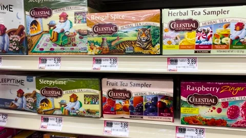 Retail grocery store Celestial herbal tea in a box and price tags on a shelf Video stock 203963459