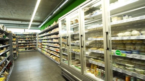 Retail grocery store refrigerators, with shelves decked up with consumer Stock Footage