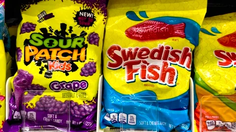 Retail grocery store Sour Patch Swedish Worms gummy worms bag candy in the ca Vídeos de archivo 201340627