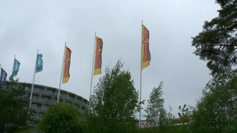 Retail store flags waving in the wind with cloud overcast in the background. Stock Footage 310449649