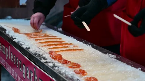 Retailer Making Maple Syrup Sugar with Sticks on Ice and Selling on Street Stock Footage 232959834
