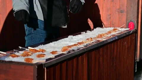 Retailer Making Maple Syrup Sugar with Sticks on Ice and Selling on Street Stock Footage 232960422