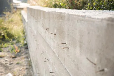 Retaining concrete wall. Side view. Reinforcement elements protrude from the Stock Photos