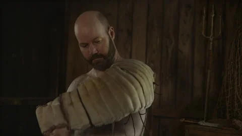 Retiarius Gladiator Putting on Manica and Preparing for Battle Stock Footage 342023760