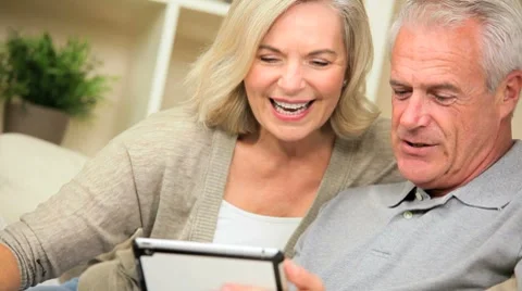 Retired Caucasian Couple Using a Wireless Tablet Stock Footage 8963293