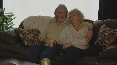 Retired Couple Cuddle on Couch Stock Footage 35320955