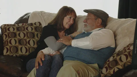 Retired Couple Cuddling on Couch Stock Footage 35326870