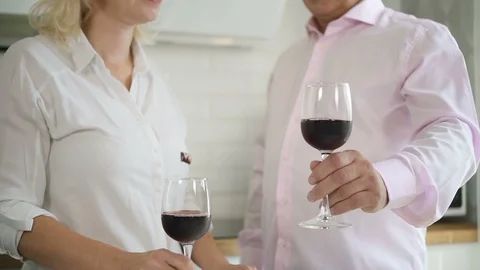 Retired couple drinking wine in kitchen. Video stock 102816561