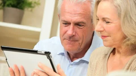 Retired Couple Using Wireless Tablet Technology Stock Footage 8975190