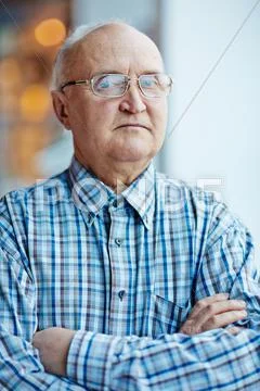 Retired cross-armed man looking at camera Stock Photos
