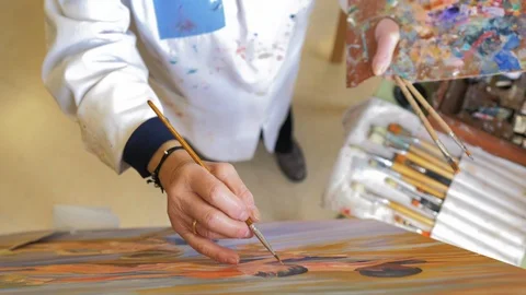 Retired lady in the process of painting Stock Footage 124365778