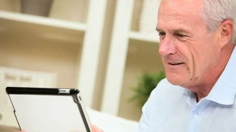 Retired Male Using a Modern Wireless Tablet Stock Footage 8975152