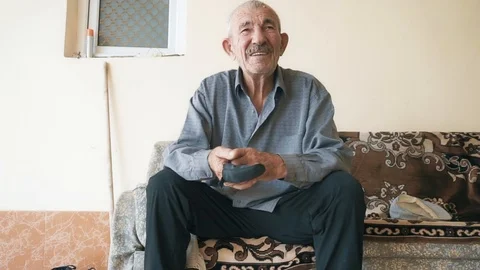 Retired man on couch closeup Stock Footage 95679482