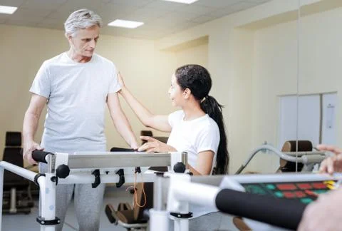 Retired man looking attentive while being in a modern gym Stock Photos