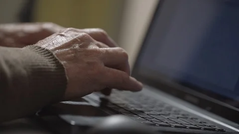 Retired man types document on laptop working on Internet Stock Footage 126756236
