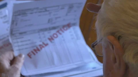 Retired old man looking at overdue bills on table OTS Stock Footage 67340318