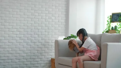 A retired old man uses a vacuum cleaner to clean the floors, with a young gra Stock Footage 153343257