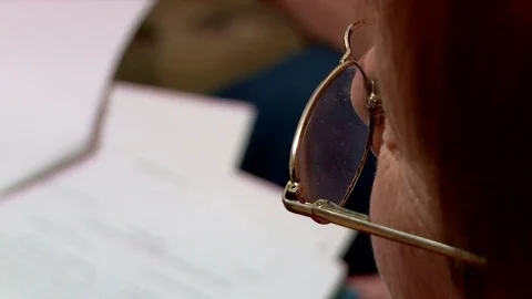 Retired reading documents kupno through the glasses Stock Footage 72451557