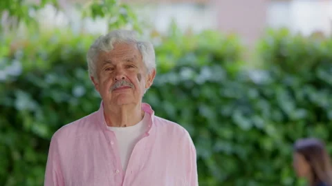 Retired Spanish math professor sharing thoughts in park with calm expression Video stock 310503492