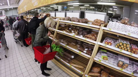 A retiree choosing bread at the store Stock Footage 55911564