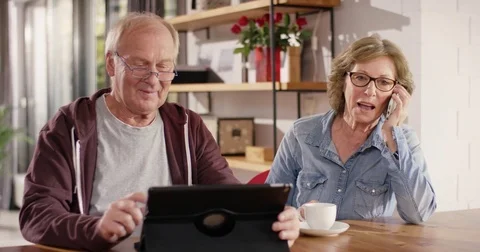 Retirees using mobile Gadgets at home Stock-Footage 82180963