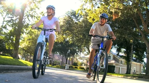 Retirement Cycling Exercise by Healthy Senior Couple Stock Footage