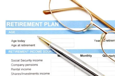 Retirement plan document with pen and glasses Stock Photos