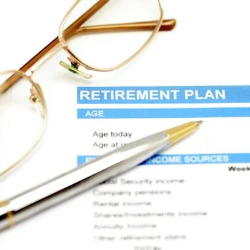 Retirement plan document with pen and glasses Stock Photos