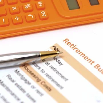 Retirement plan document with pen and calculator Stock Photos