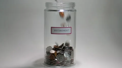 Retirement Savings Jar filled with coins Stock Footage
