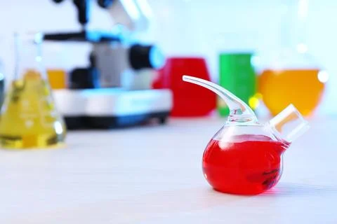 Retort flask with sample on table in chemistry laboratory, space for text Stock Photos