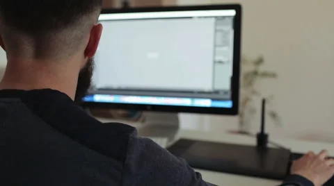 Retoucher man works at the computer - digital photo processing Stock Footage 49886538