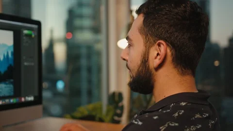 Retoucher working from home on computer, view of Downtown LA Stock Footage 127402158