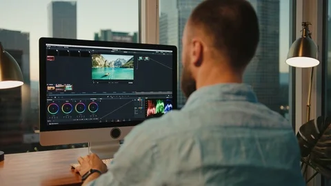 Retoucher working from home on computer, view of Downtown LA 스톡 동영상 127402186