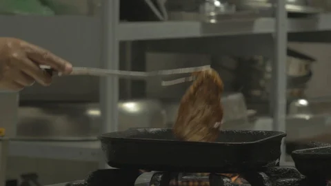 Retracing a meat while roasting on a heated pan Stock Footage 109210473