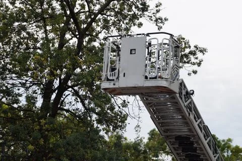 Retractable fire stairs on the background of trees Stock Photos
